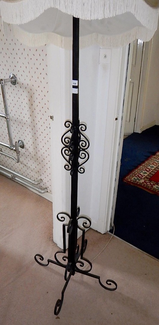 Appraisal: A wrought iron standard lamp with square section column and