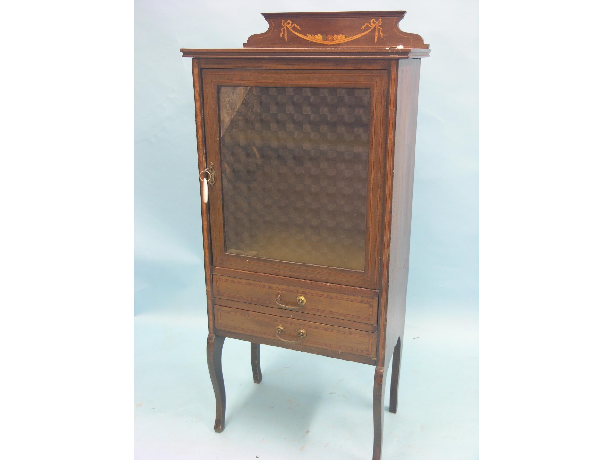 Appraisal: An Edwardian inlaid mahogany display cabinet enclosed by single glazed