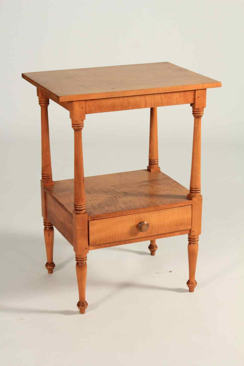 Appraisal: CUSTOM ONE-DRAWER STANDIn tiger maple with turned legs Height Width