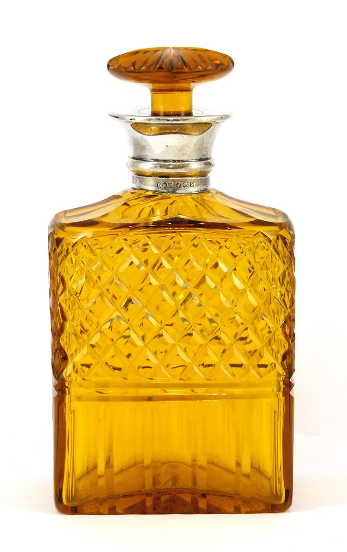 Appraisal: A silver mounted faceted amber coloured glass decanter and stopper