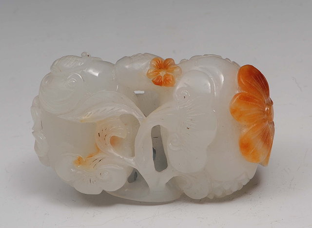 Appraisal: A Chinese white jade carving of fruit th Centurywith russet