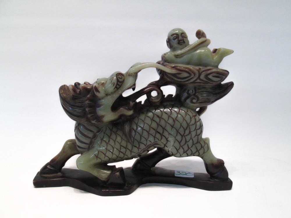 Appraisal: CARVED HARDSTONE DRAGON with a small boy perched above his