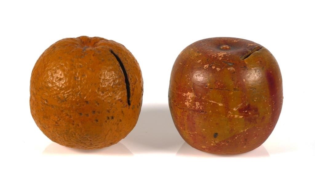 Appraisal: Antique primitive pottery redware orange and apple still banks Roughly