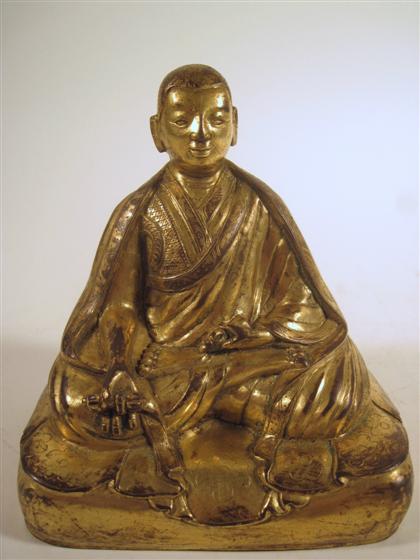 Appraisal: Sino Tibetan gilt bronze lama figureSingle cast figure draped in