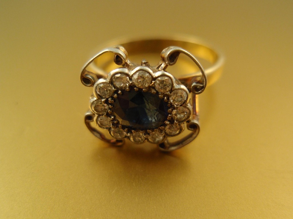 Appraisal: A diamond and sapphire cluster ring a central sapphire of