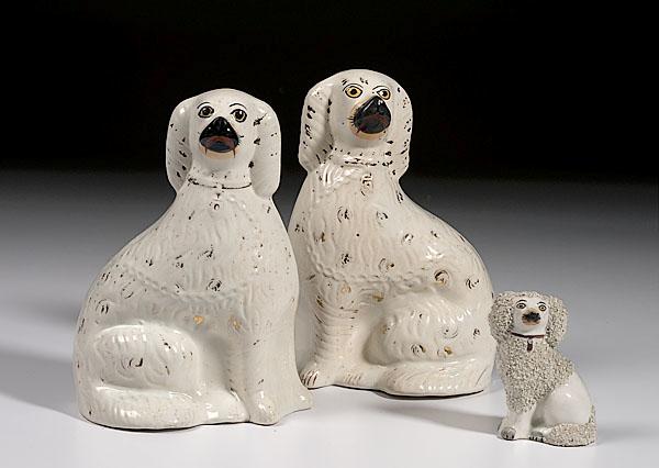 Appraisal: THREE STAFFORDSHIRE COMFORTER SPANIELS English late th century of earthenware