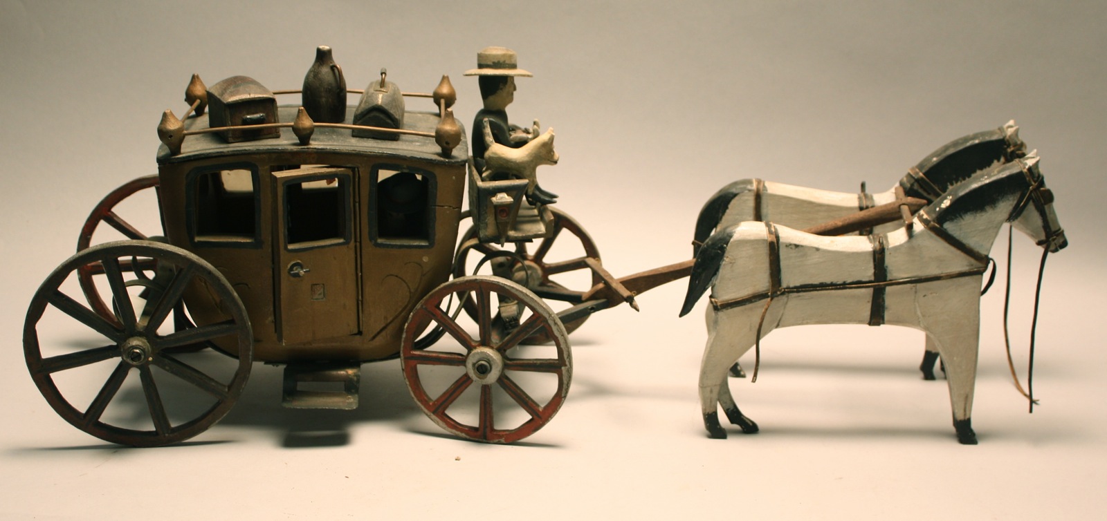 Appraisal: HAND-CARVED STAGECOACH AND FIGURES Late th CenturyIncludes two white and