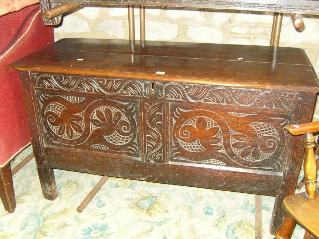 Appraisal: An th century oak panelled coffer with carved and scrolling