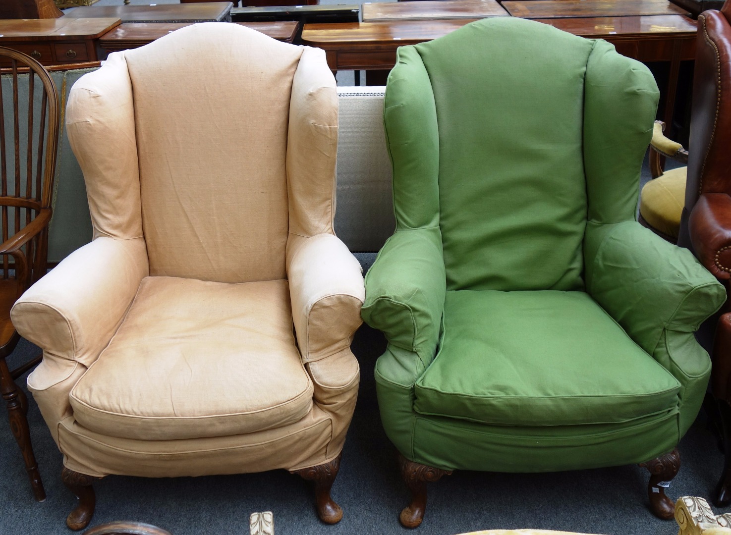 Appraisal: A pair of th century style wingback armchairs on walnut