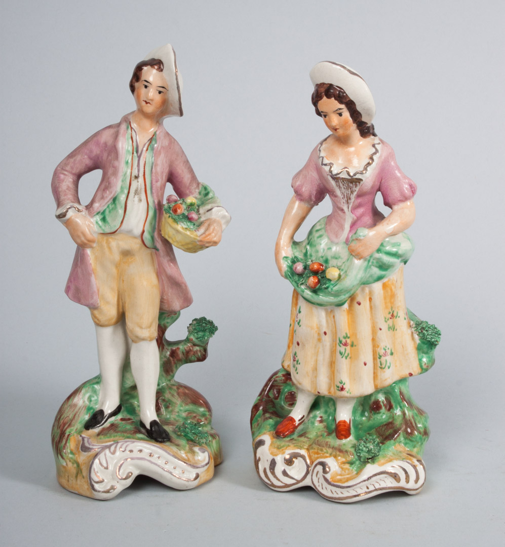 Appraisal: Pair of Staffordshire earthenware flower gatherers each modeled as boy