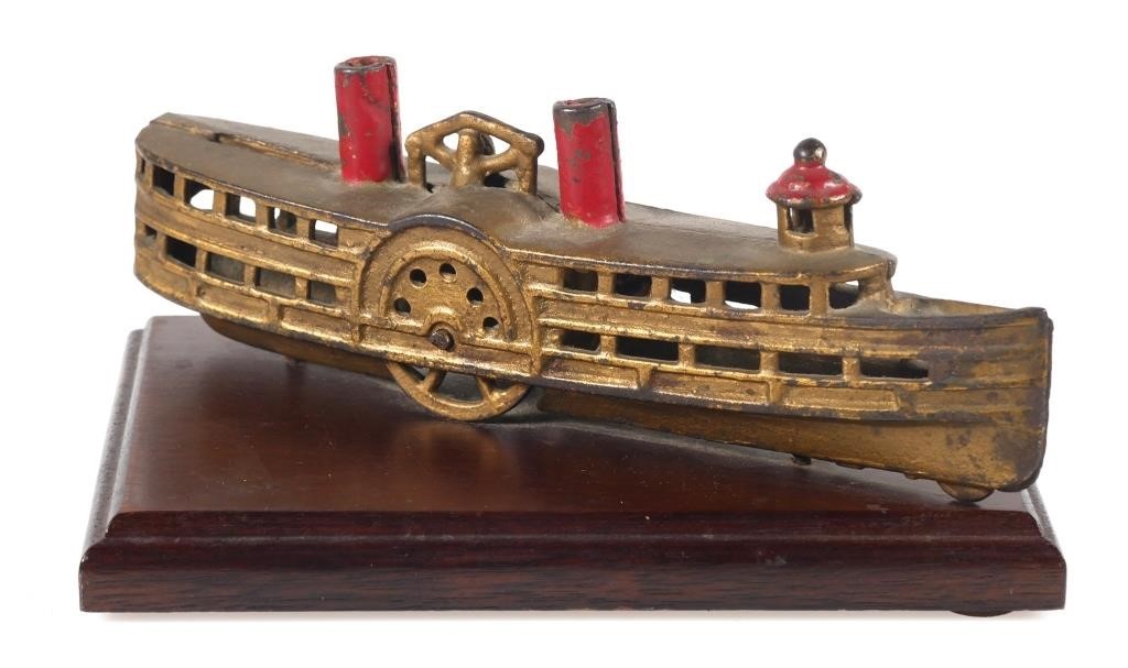 Appraisal: Cast iron paddle wheel or steamboat still bank on wood