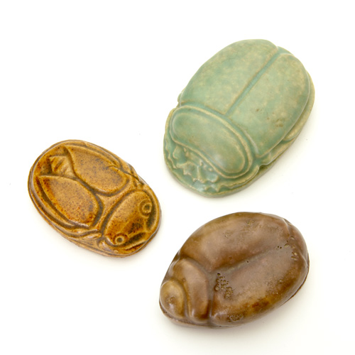 Appraisal: GRUEBY AREQUIPA Three scarab paperweights one light green by Grueby