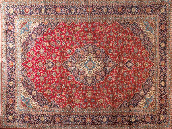 Appraisal: PERSIAN KASHAN Room-size rug with a ruby-red floral ground and