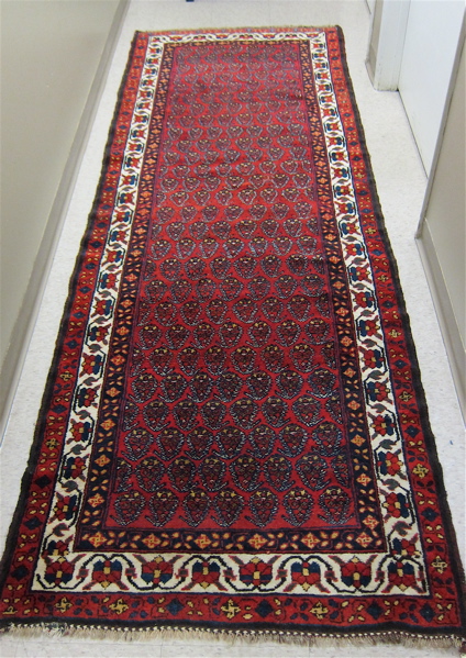 Appraisal: SEMI-ANTIQUE PERSIAN HALL RUG hand knotted in an overall boteh