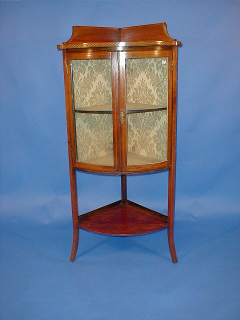 Appraisal: An Edwardian string inlaid bow front china cabinet