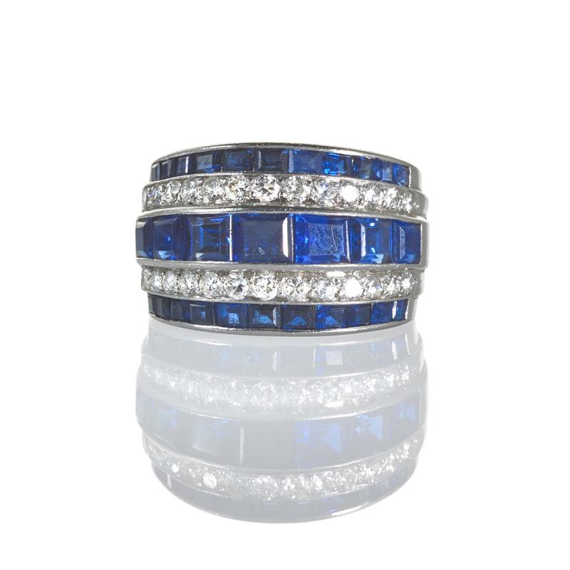 Appraisal: SAPPHIRE AND DIAMOND PLATINUM BAND RING Tapered setting with three