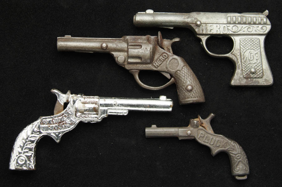 Appraisal: LOT OF FOUR CAST IRON CAP PISTOLS Includes a Hero