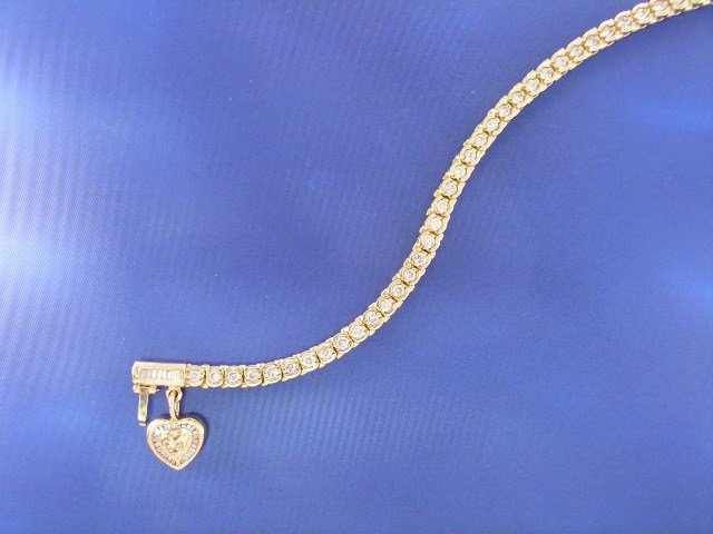 Appraisal: A ct gold diamond line bracelet with a diamond set