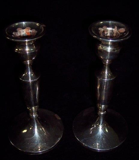 Appraisal: A pair of candlesticks each of turned form on a