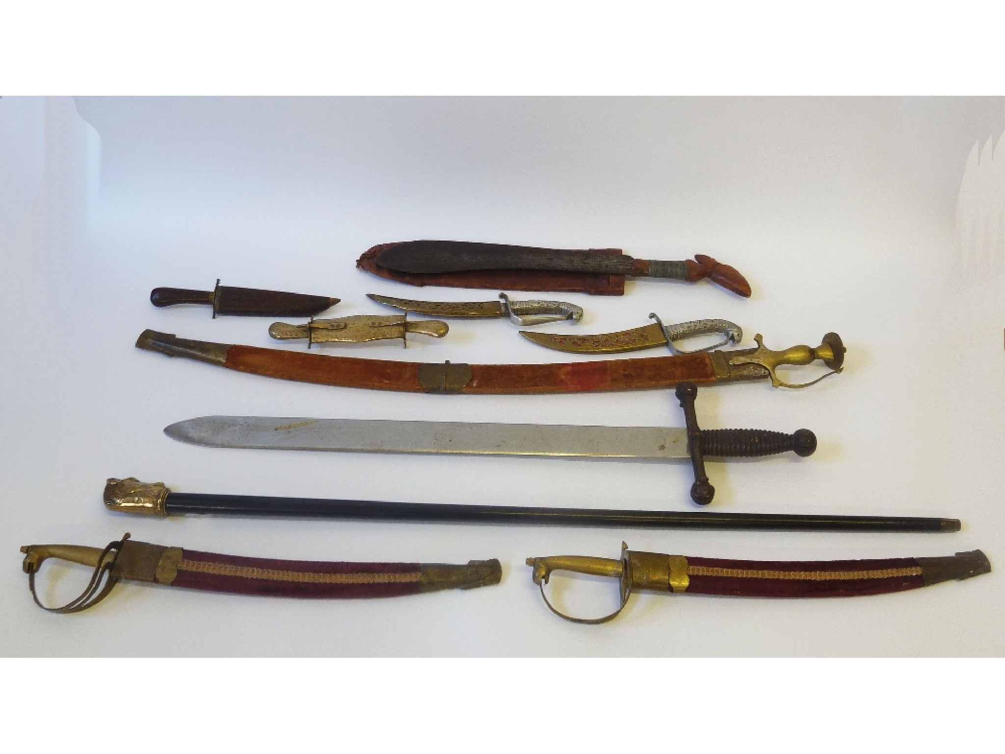 Appraisal: EIGHT VARIOUS REPRODUCTION SWORDS AND DAGGERS includes Indian brass hilted