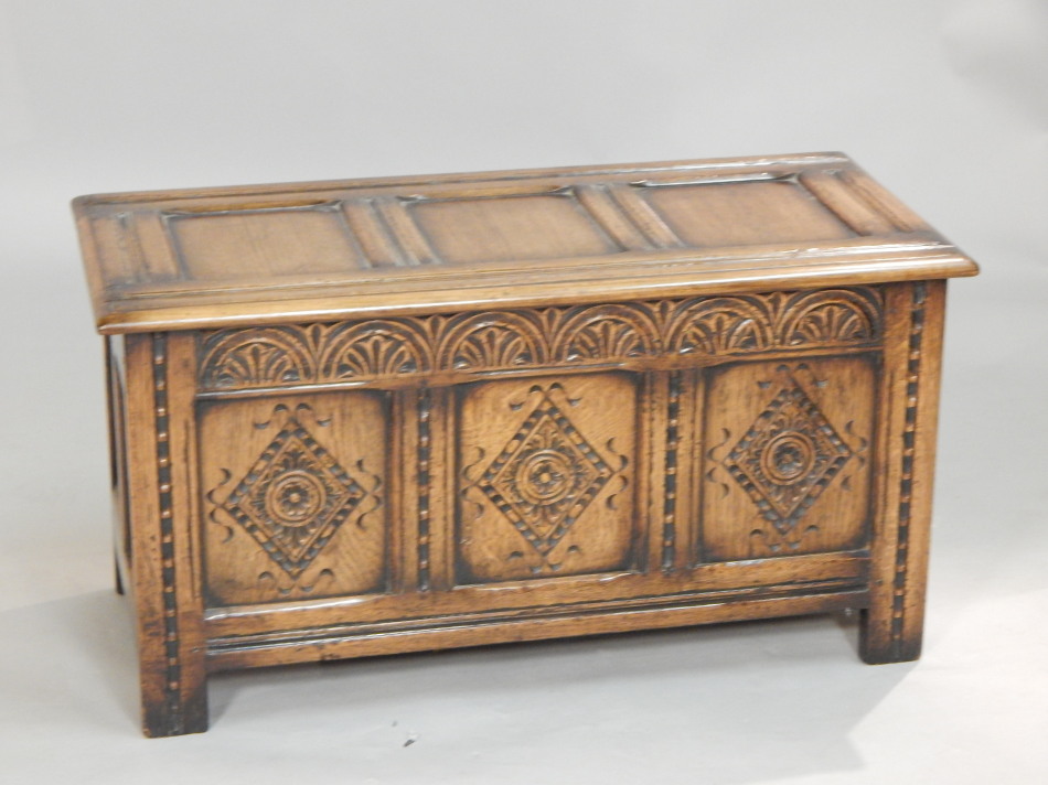 Appraisal: A Titchmarsh and Goodwin panelled oak coffer the top with