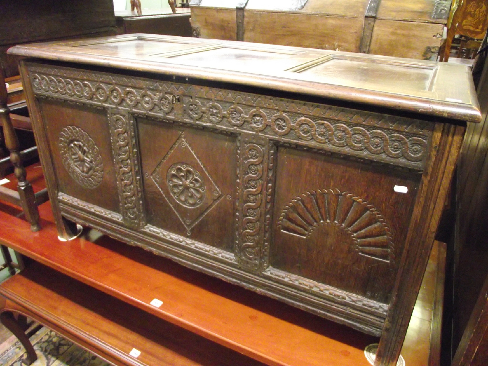 Appraisal: An th century oak coffer the front elevation enclosed by