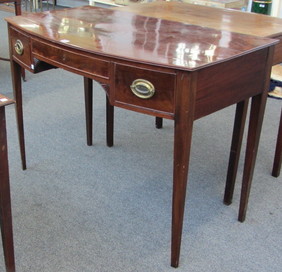 Appraisal: A th century mahogany bowfront three drawer writing table on