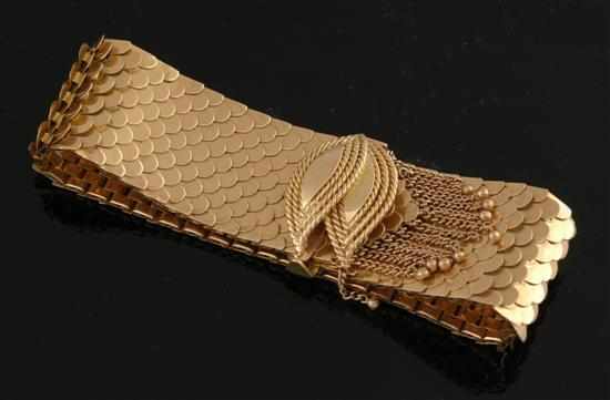 Appraisal: A gold cocktail bracelet The wide bracelet of snake skin