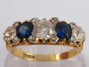 Appraisal: An antique carat gold diamond and sapphire carved half hoop