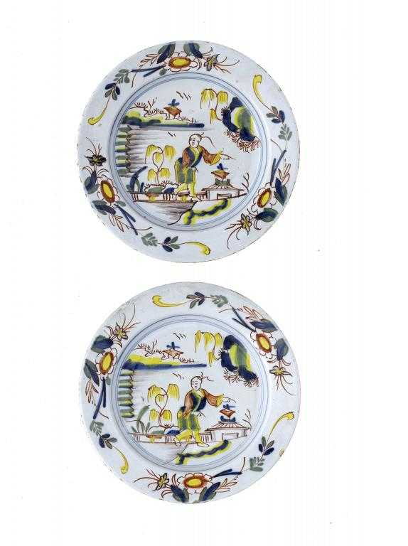 Appraisal: A PAIR OF ENGLISH DELFTWARE POLYCHROME PLATES freely painted with