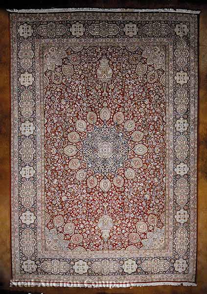 Appraisal: A Persian Kerman Carpet red ground central medallion and spandrels