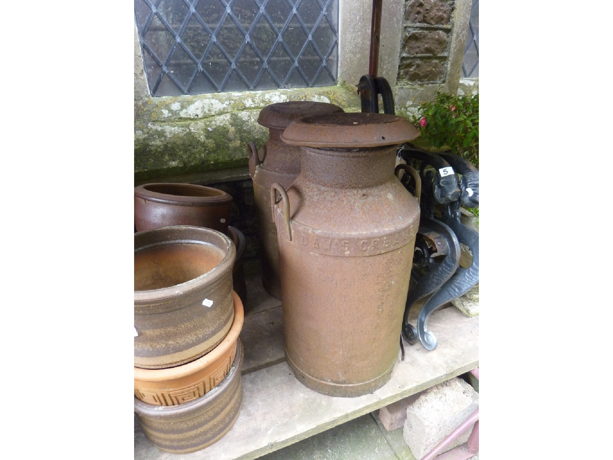 Appraisal: Two vintage cast iron milk churns complete with caps with