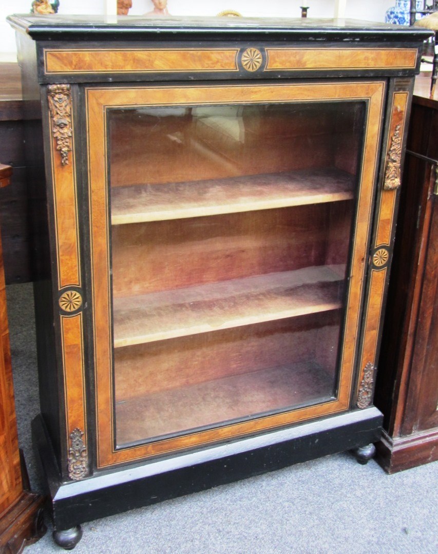 Appraisal: A late Victorian ebonised and walnut display cabinet with fan