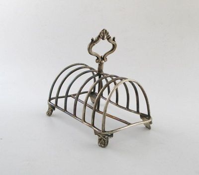 Appraisal: A Victorian silver seven bar toast rack of arched form