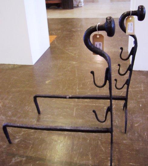 Appraisal: A pair of wrought iron fire dogs with button finials