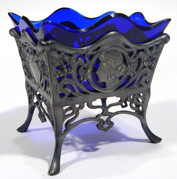 Appraisal: Art Nouveau pierced pewter stand with blue glass liner decorated