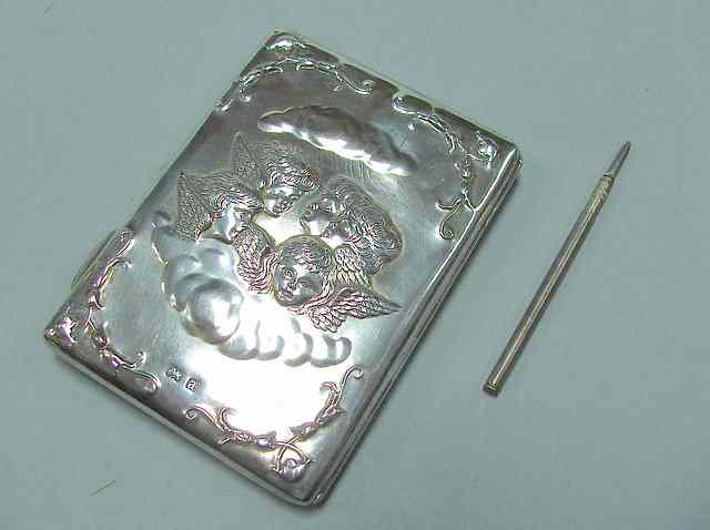 Appraisal: AN EDWARDIAN SILVER PURSE rectangular shape with pressed cherub decoration