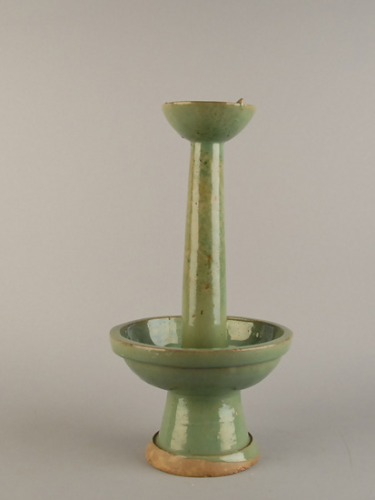 Appraisal: An Early Chinese Celadon Oil Lamp Candlestick having a shallow