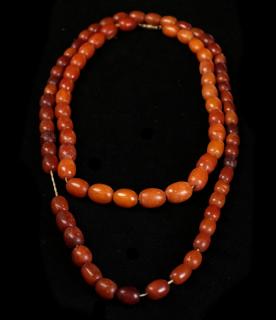 Appraisal: Two Amber Necklaces Comprising long amber necklace small bead mm