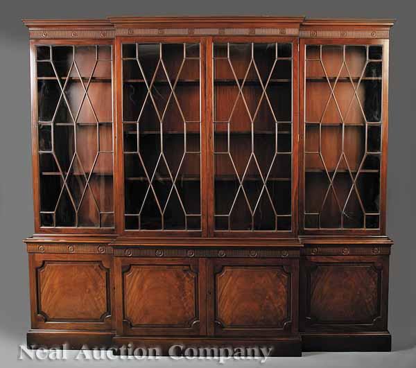 Appraisal: A Monumental Georgian-Style Carved Mahogany Breakfront Bookcase labeled Baker with