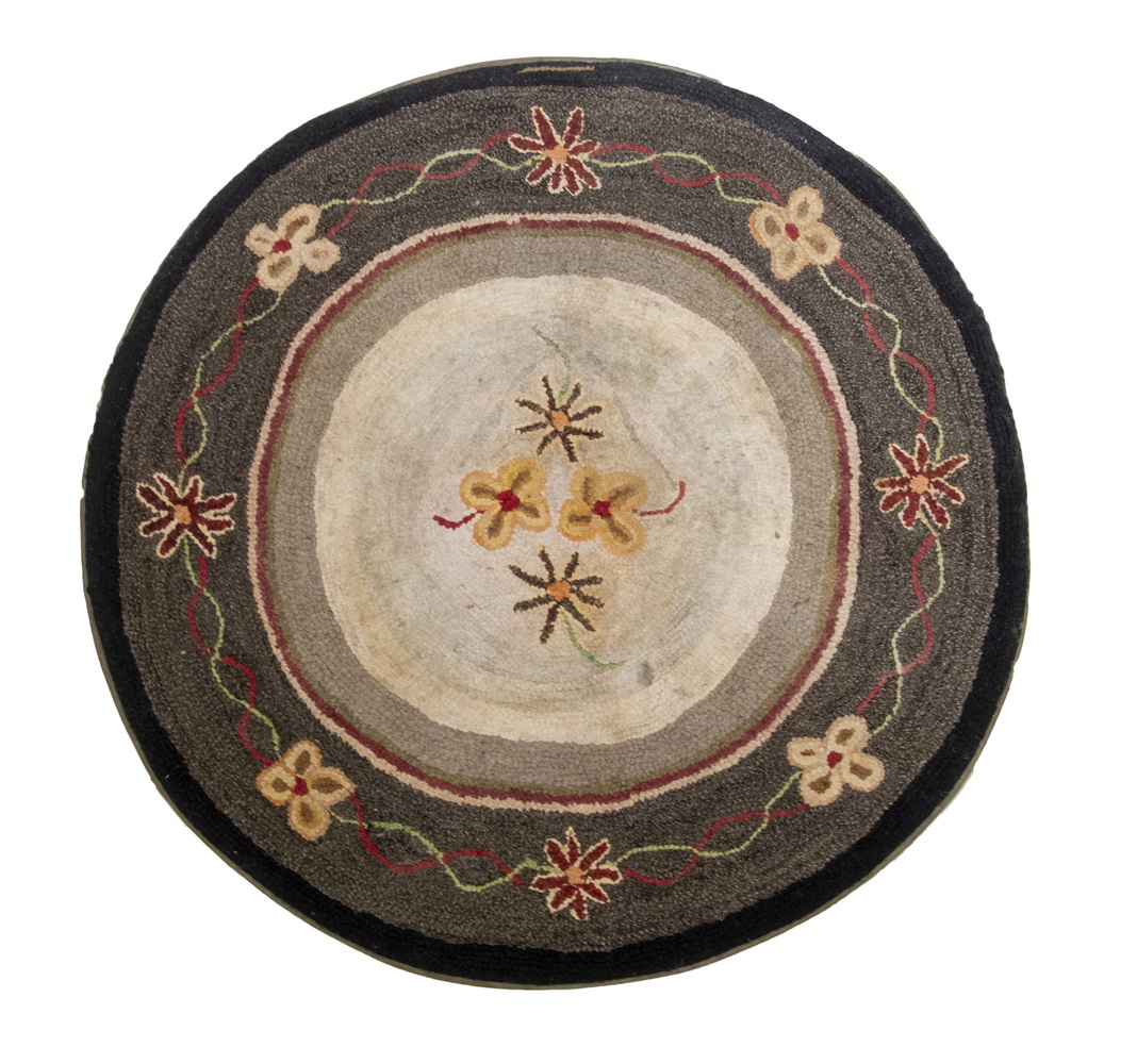 Appraisal: ROUND FLORAL HOOKED RUG Circa Freehand Flowers ring a tan