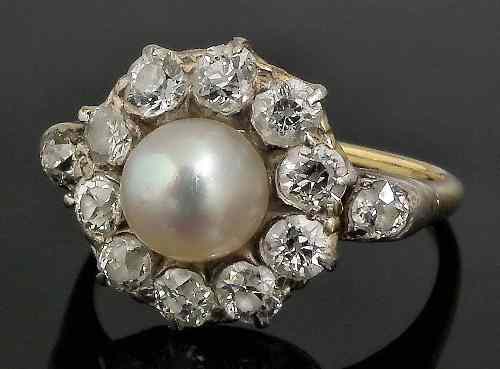 Appraisal: An Edwardian gold coloured metal mounted pearl and diamond flowerhead