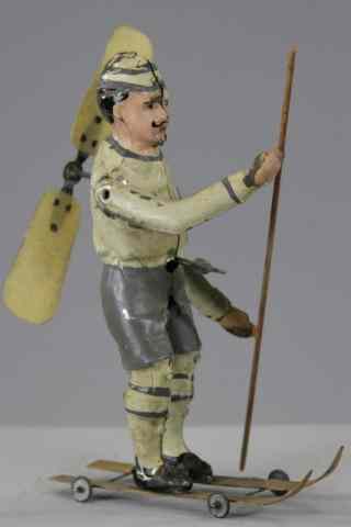 Appraisal: MAN ON SKIS WITH PROPELLER Germany hand painted tin curious