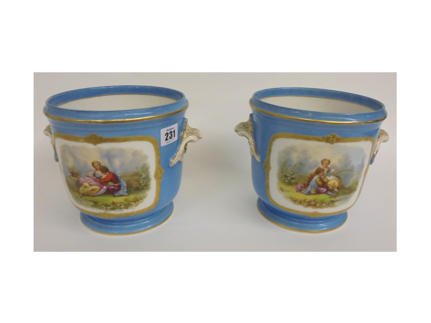 Appraisal: A pair of Sevres style porcelain cache pot painted with