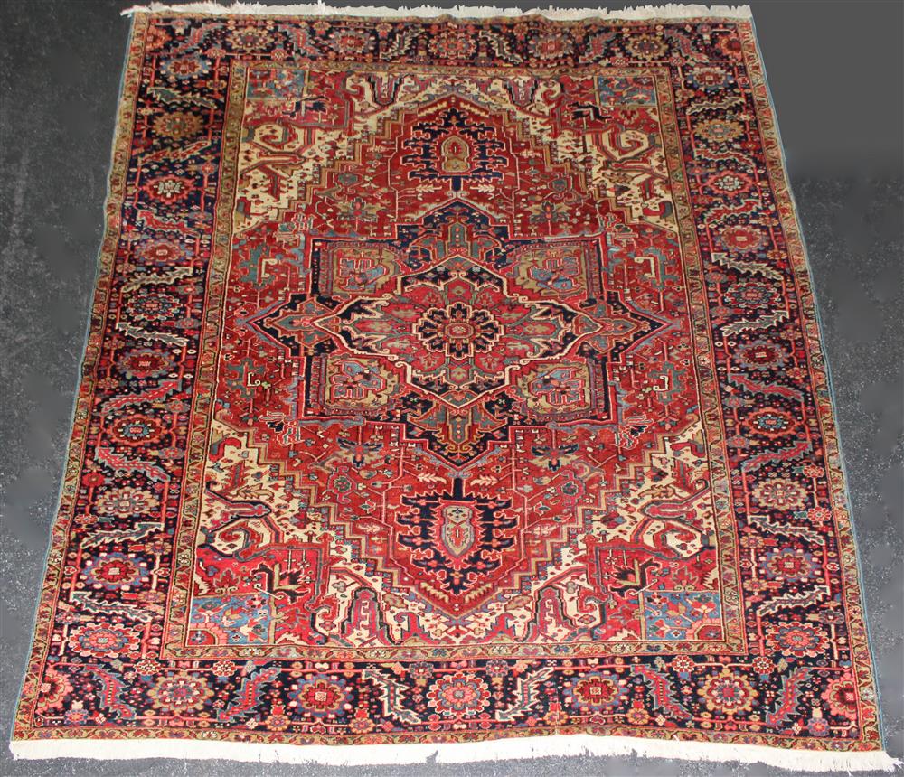 Appraisal: PERSIAN HERIZ WOOL RUG central medallion with corner spandrels and