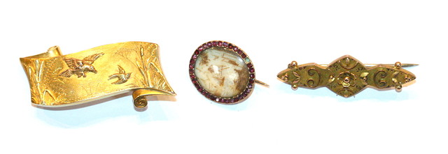 Appraisal: A GOLD BROOCH in the form of a scroll decorated