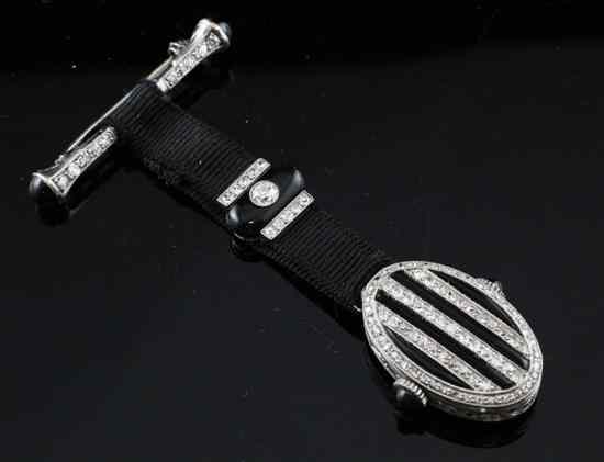 Appraisal: A 's ct white gold diamond and black onyx fob