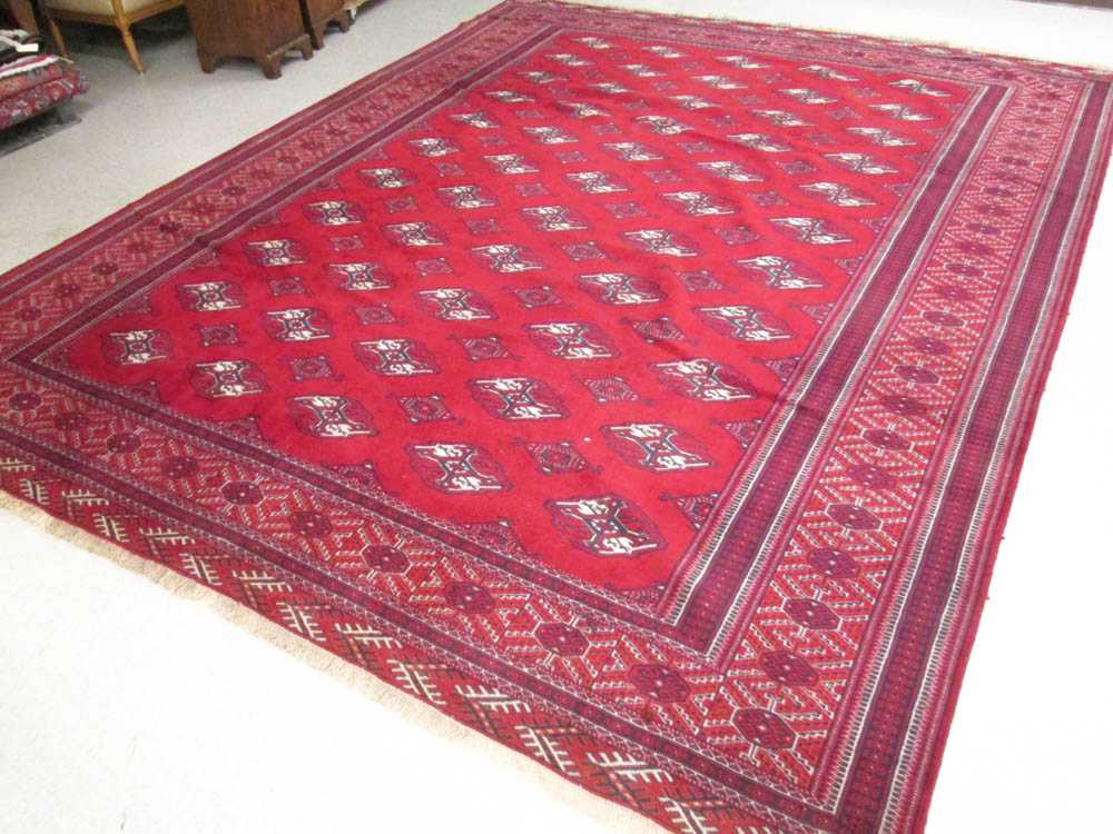 Appraisal: PERSIAN TURKOMAN BOKHARA CARPET repeating columns of geometric gols on