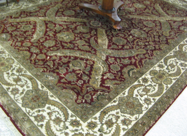 Appraisal: HAND KNOTTED ORIENTAL CARPET Indo-Persian overall floral design on ruby