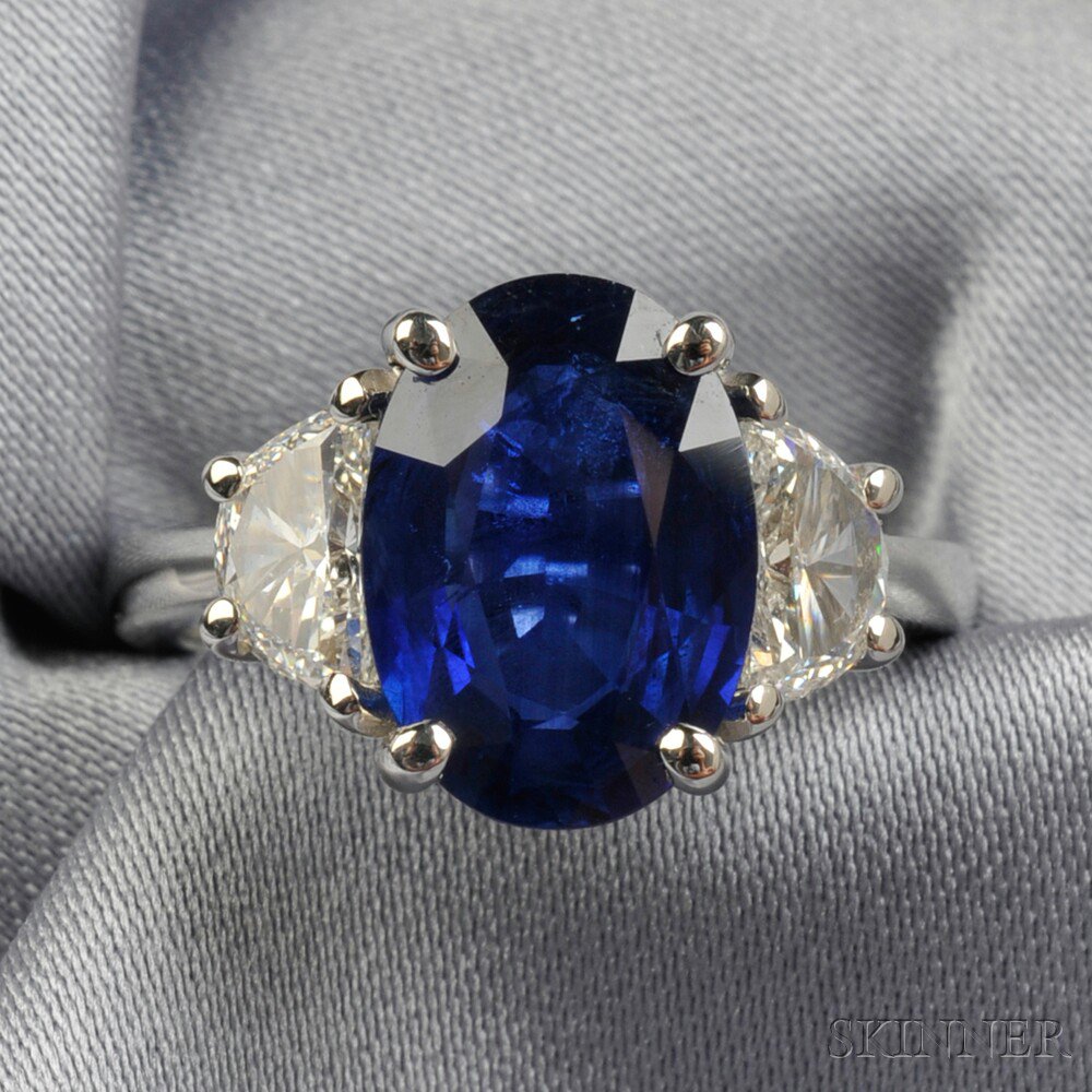 Appraisal: Platinum Sapphire and Diamond Ring prong-set with an oval-cut sapphire